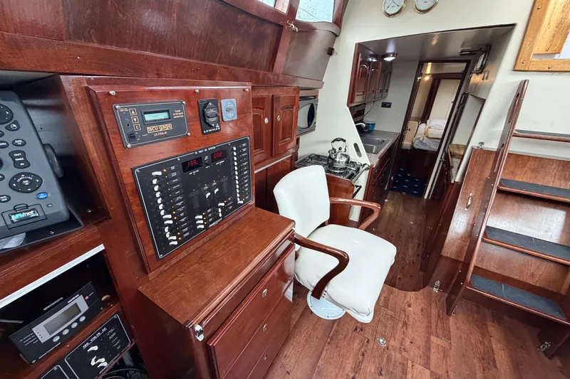 Slide: The Image of Interior of 2011 Custom Build 50' Ketch, featuring control panel and cozy seating. - 28