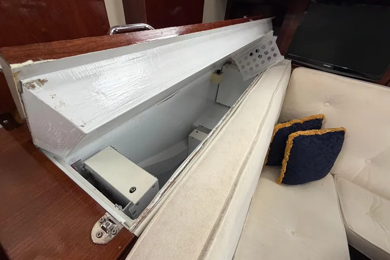 Slide: The Image of Interior view of 2011 Custom Build 50' Ketch, featuring storage compartment and cushioned seating. - 30