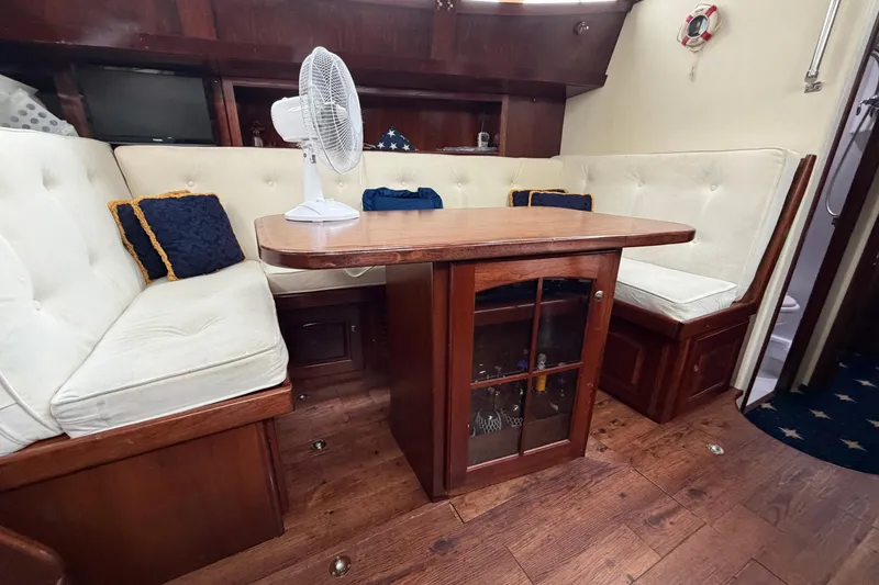 Slide: The Image of Interior of 2011 Custom Build 50' Ketch with wooden table and cushioned seating. - 32