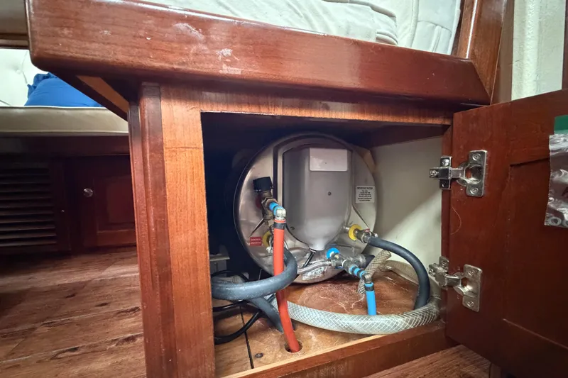 Slide: The Image of Wooden cabinet housing plumbing system on a 2011 Custom Build 50' Ketch sailboat. - 37