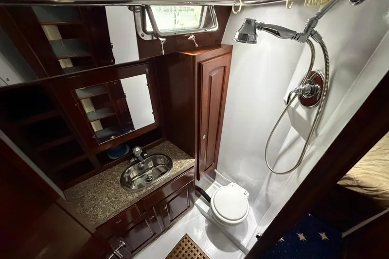 Slide: The Image of Luxurious 2011 Custom Build 50' Ketch bathroom with shower, sink, and wooden cabinetry. - 40