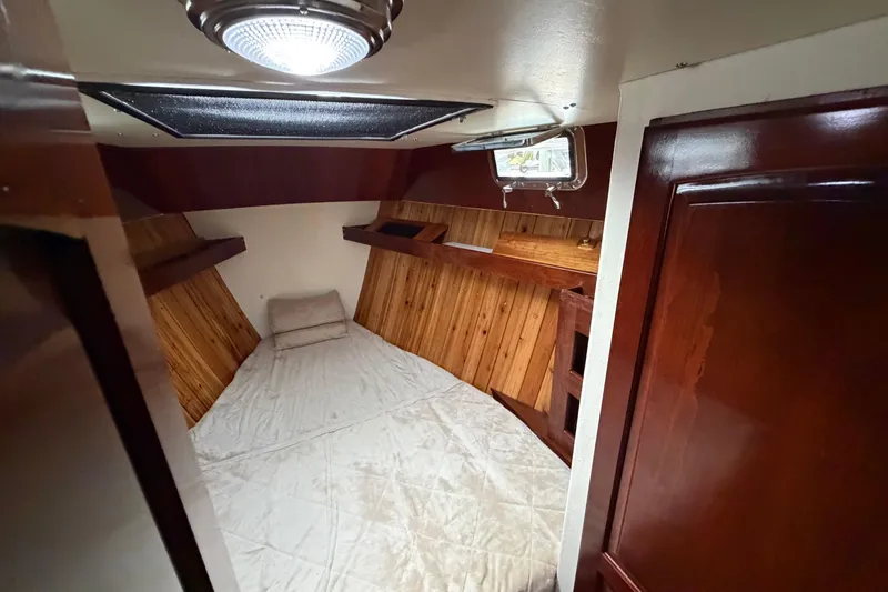 Slide: The Image of Cozy cabin interior of 2011 Custom Build 50' Ketch, featuring wood paneling and a skylight. - 43