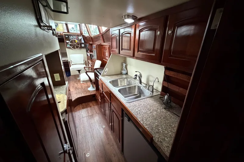 Slide: The Image of Luxurious interior of 2011 Custom Build 50' Ketch, featuring elegant wood cabinetry and modern amenities. - 45