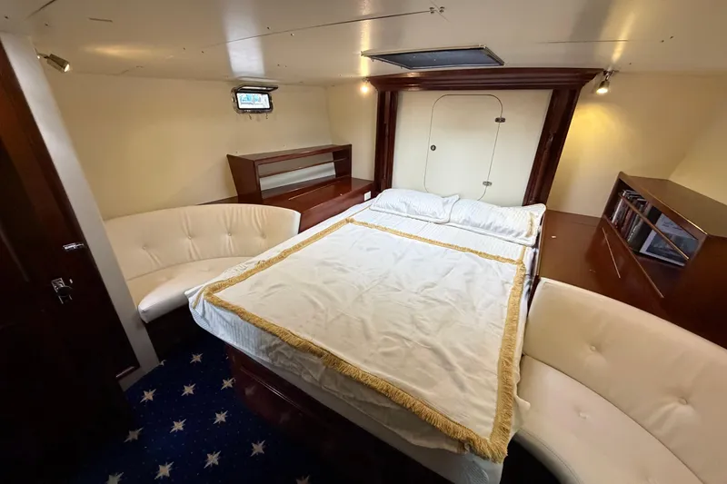 Slide: The Image of Luxurious cabin interior of 2011 Custom Build 50' Ketch, featuring elegant woodwork and cozy seating. - 48