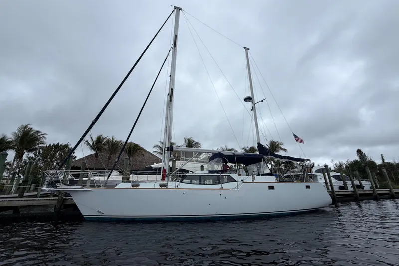 The Image of Custom Build 50' Ketch, 2011, docked under cloudy skies, palm trees in background. - 0