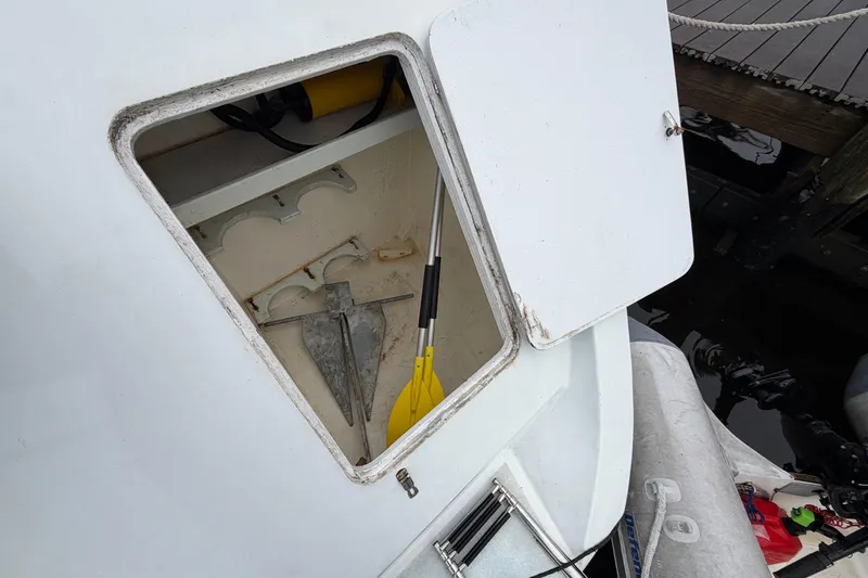 Slide: The Image of Open storage compartment on 2011 Custom Build 50' Ketch, showing anchor and paddle. - 5