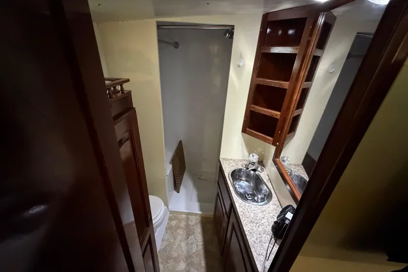 Slide: The Image of Luxurious bathroom in 2011 Custom Build 50' Ketch, featuring wood cabinetry and modern fixtures. - 54