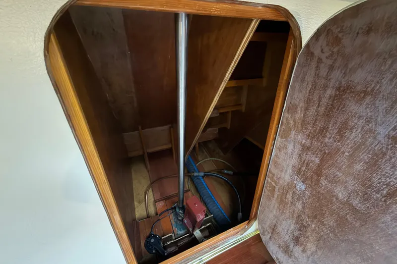 Slide: The Image of Interior view of 2011 Custom Build 50' Ketch, showcasing wooden craftsmanship and mechanical components. - 56