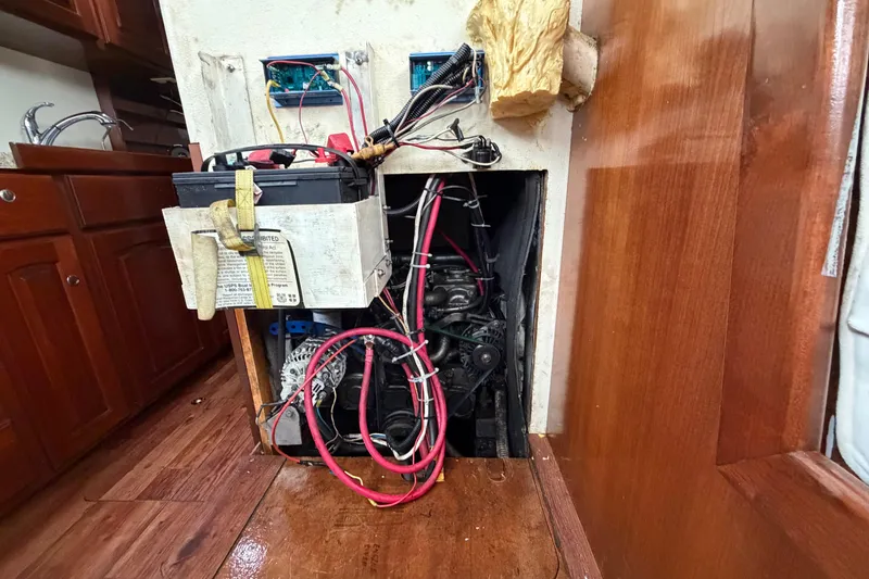 Slide: The Image of Electrical setup inside 2011 Custom Build 50' Ketch, showcasing wiring and battery components. - 61