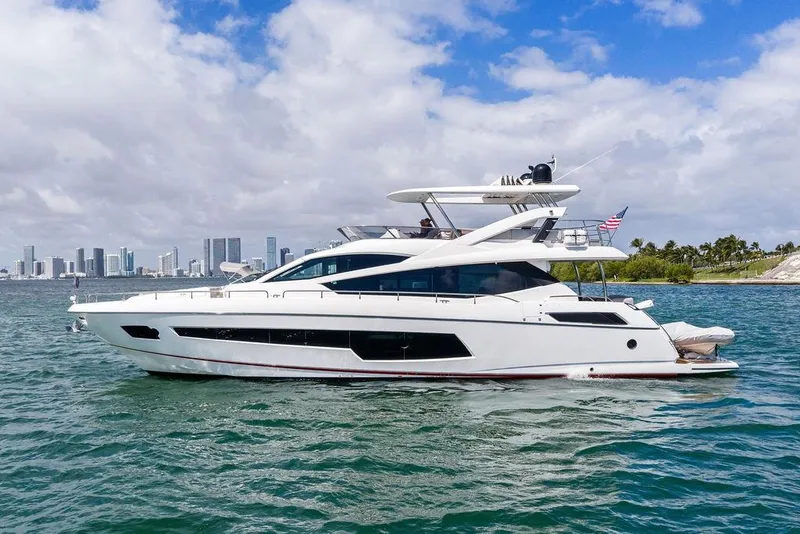 Slide: The Image of 2018 Sunseeker 75 Sport Yacht cruising near city skyline under cloudy sky. - 12