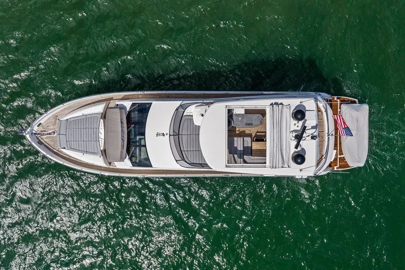 Slide: The Image of Aerial view of 2018 Sunseeker 75 Sport Yacht on green water. - 15