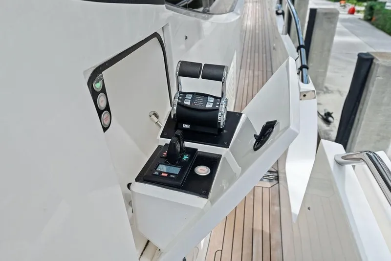 Slide: The Image of Control panel of a 2018 Sunseeker 75 Sport Yacht, featuring throttle and navigation controls. - 24