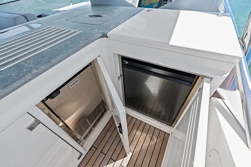 Slide: The Image of Sunseeker 75 Sport Yacht 2018, open storage compartments on deck with wooden flooring. - 29