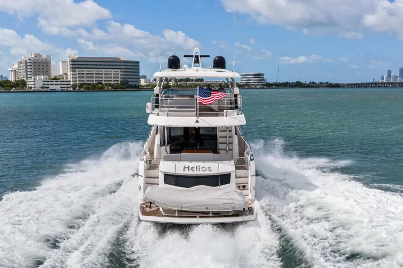 Slide: The Image of Sunseeker 75 Sport Yacht 2018 cruising on water with cityscape background. - 3