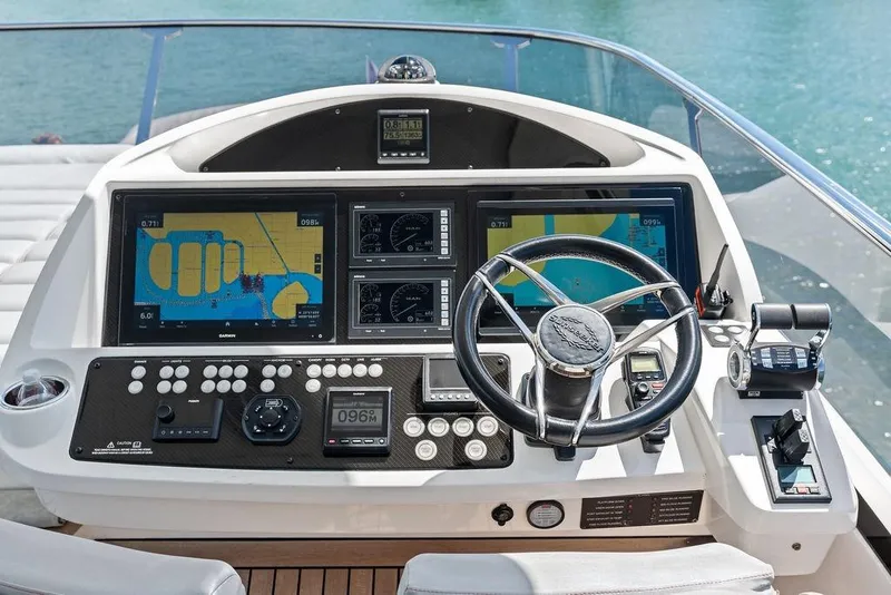 Slide: The Image of Cockpit of 2018 Sunseeker 75 Sport Yacht with navigation screens and controls. - 30