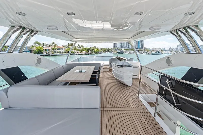 Slide: The Image of Luxurious 2018 Sunseeker 75 Sport Yacht deck with elegant seating and scenic waterfront views. - 34