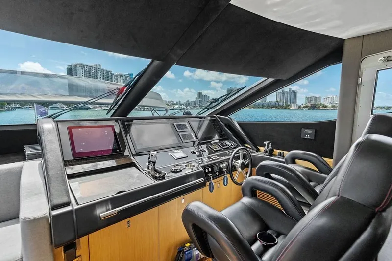 Slide: The Image of Interior cockpit of 2018 Sunseeker 75 Sport Yacht with modern controls and cityscape view. - 48
