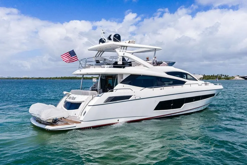 Slide: The Image of 2018 Sunseeker 75 Sport Yacht cruising on blue waters under a clear sky. - 5