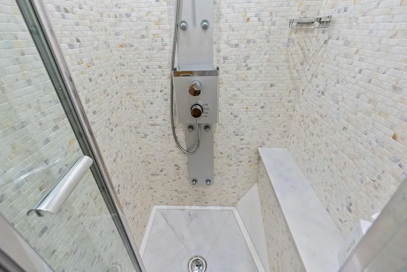 Slide: The Image of Shower area in 2018 Sunseeker 75 Sport Yacht with modern fixtures and tiled walls. - 53