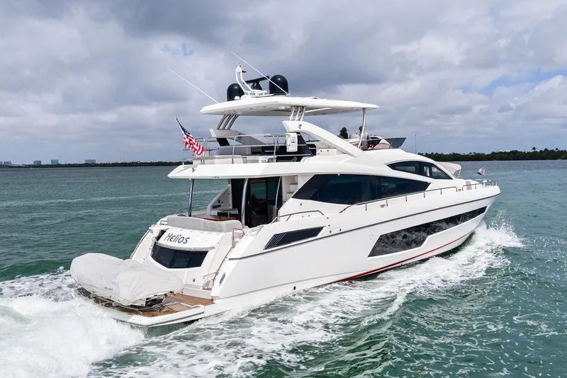 Slide: The Image of 2018 Sunseeker 75 Sport Yacht cruising on open water under cloudy skies. - 6