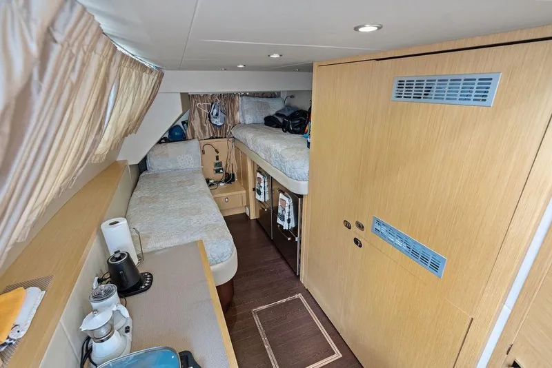 Slide: The Image of Interior cabin of 2018 Sunseeker 75 Sport Yacht with twin beds and wooden finishes. - 76