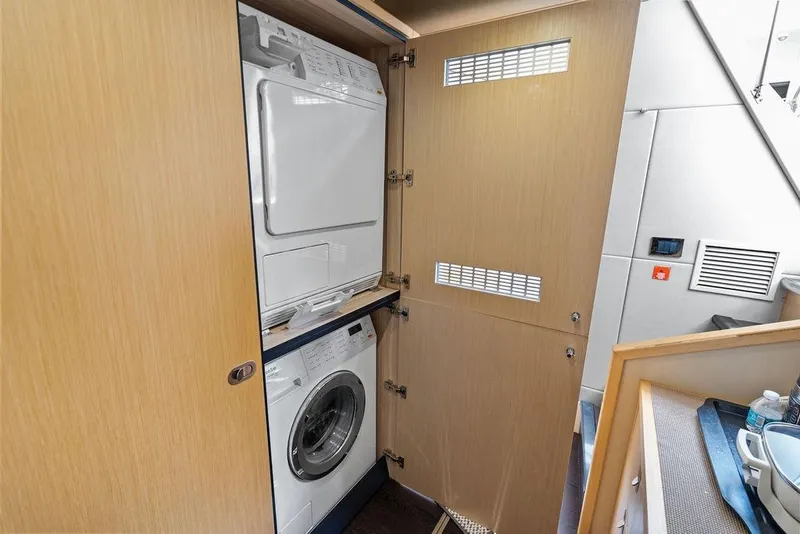 Slide: The Image of Laundry area with washer and dryer on 2018 Sunseeker 75 Sport Yacht. - 77