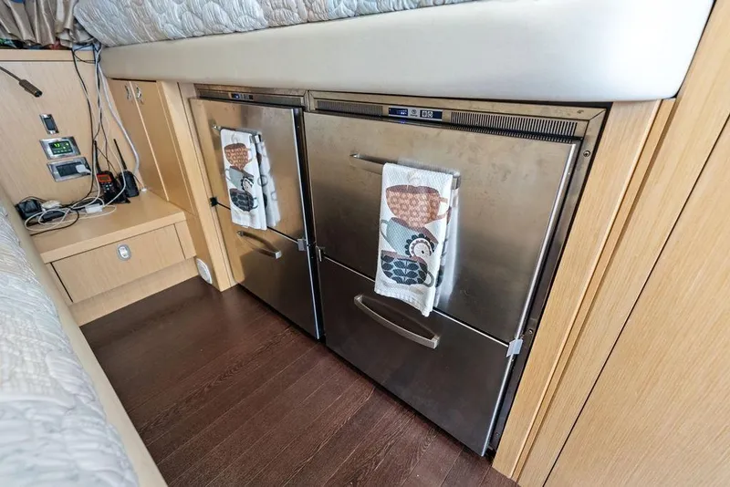 Slide: The Image of Interior of 2018 Sunseeker 75 Sport Yacht with stainless steel appliances and wooden cabinetry. - 78