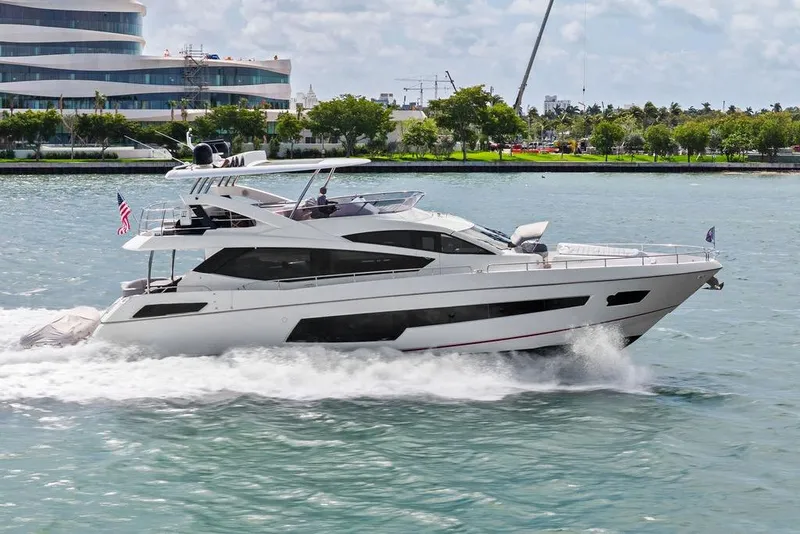 Slide: The Image of 2018 Sunseeker 75 Sport Yacht cruising on water near modern buildings. - 9