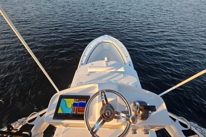 Slide: The Image of 2019 Yellowfin 42 Offshore boat dashboard with navigation system on open water. - 10