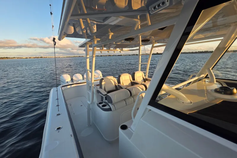 Slide: The Image of 2019 Yellowfin 42 Offshore boat on calm water at sunset. - 13
