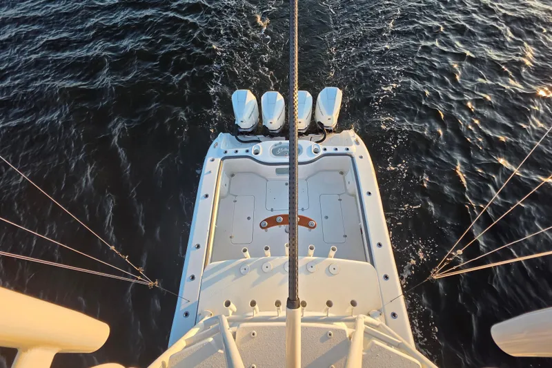 Slide: The Image of 2019 Yellowfin 42 Offshore boat with triple engines on open water. - 14