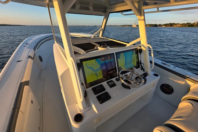 Slide: The Image of 2019 Yellowfin 42 Offshore boat dashboard with navigation screens on open water. - 17
