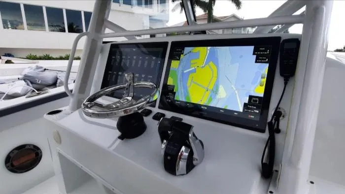 Slide: The Image of 2019 Yellowfin Center Console boat dashboard with navigation screens and controls. - 18