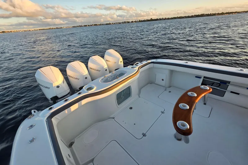 Slide: The Image of 2019 Yellowfin 42 Offshore boat with four Mercury engines on calm water. - 24