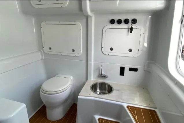 Slide: The Image of 2019 Yellowfin Center Console boat interior with toilet and sink. - 26