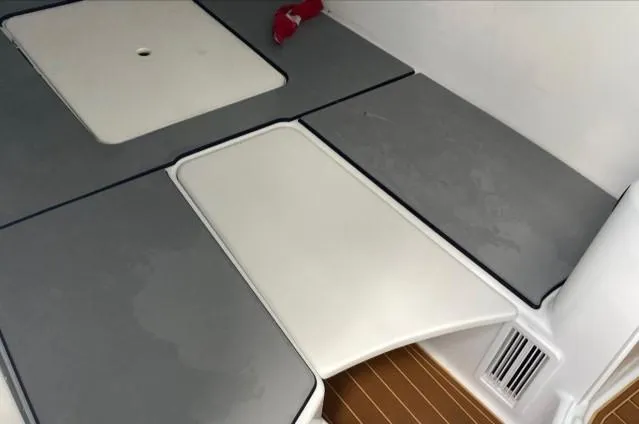 Slide: The Image of 2019 Yellowfin Center Console boat interior with cushioned seating and storage compartments. - 30