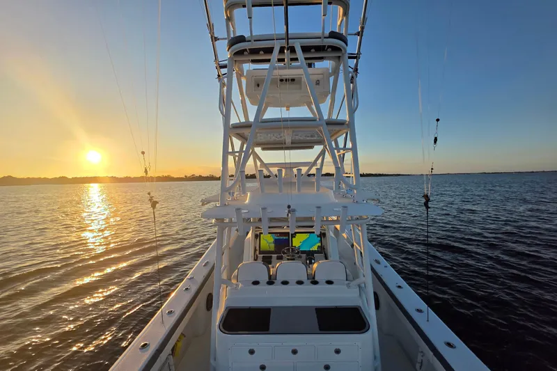 Slide: The Image of 2019 Yellowfin 42 Offshore boat at sunset on calm waters. - 7