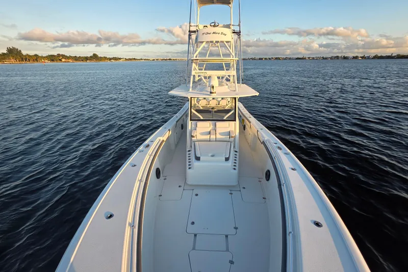 Slide: The Image of 2019 Yellowfin 42 Offshore boat on calm water at sunset. - 9