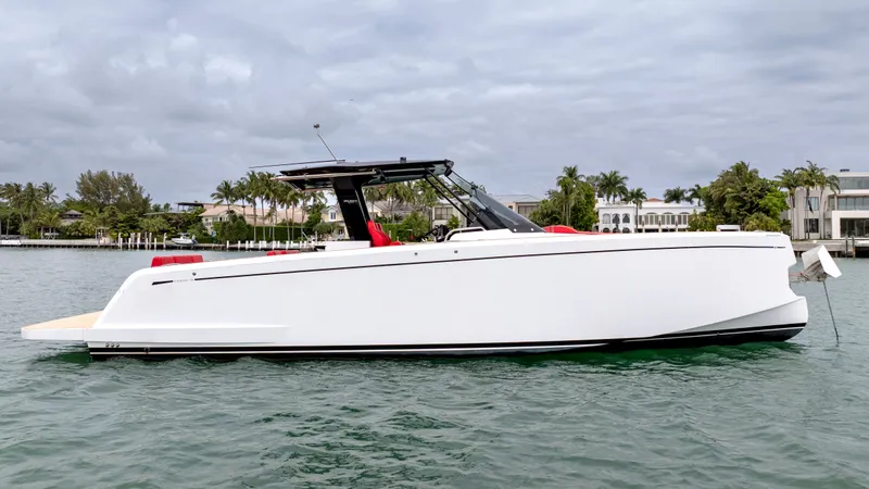 Slide: The Image of 2023 Pardo Yachts 38 on calm water near coastal homes. - 14