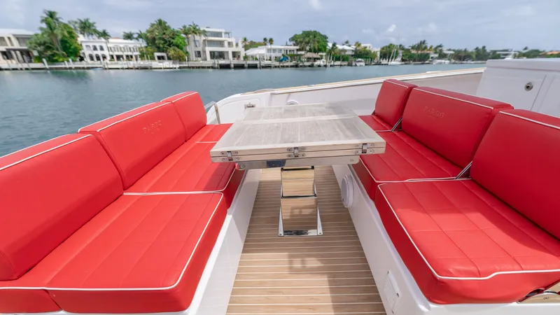 Slide: The Image of Pardo Yachts 38, 2023, featuring red seating and wooden table on deck. - 25