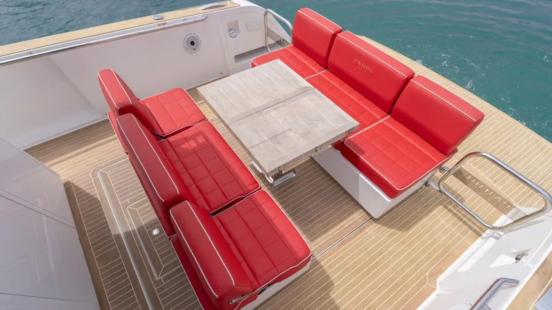 Slide: The Image of Pardo Yachts 38, 2023, featuring red seating and wooden table on deck. - 26
