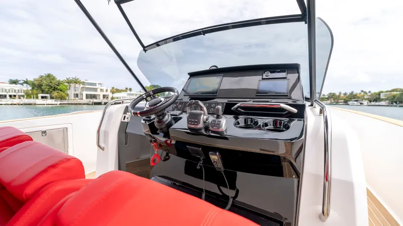 Slide: The Image of Cockpit of 2023 Pardo Yachts 38 with red seating and controls. - 31