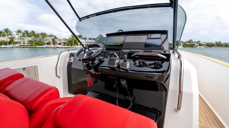 Slide: The Image of Cockpit of 2023 Pardo Yachts 38 with red seating and control console. - 42