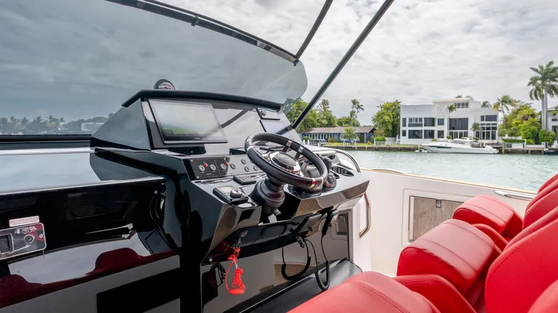 Slide: The Image of Cockpit of 2023 Pardo Yachts 38 with red seating and helm. - 44