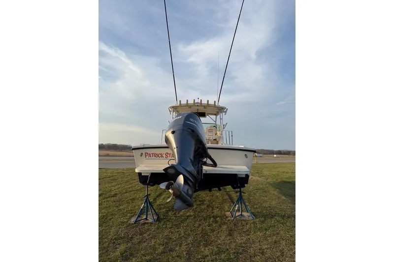 Slide: The Image of 2005 Parker 2501 Center Console boat on stands, rear view with outboard motor. - 10