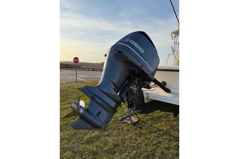 Slide: The Image of Yamaha outboard motor on 2005 Parker 2501 Center Console boat, parked on grass. - 12