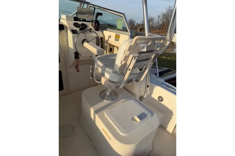 Slide: The Image of 2005 Parker 2501 Center Console boat interior with captain's chair and steering wheel. - 3