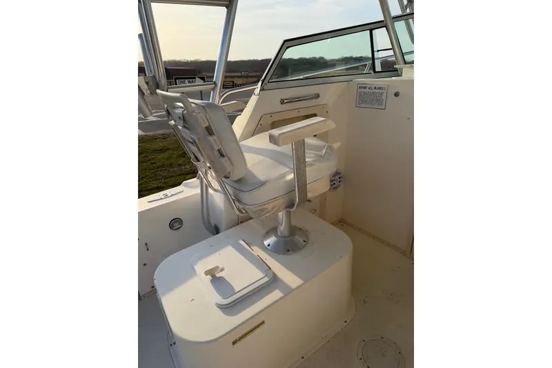 Slide: The Image of 2005 Parker 2501 Center Console boat interior with captain's chair and control panel. - 4