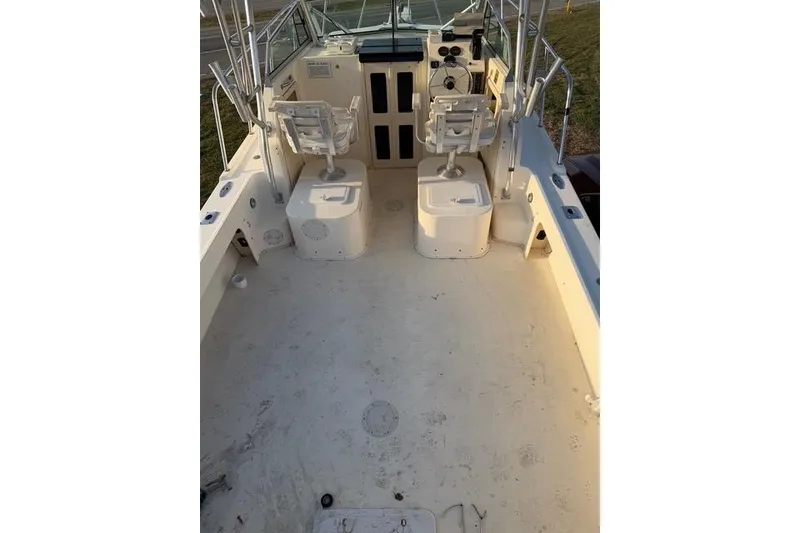 Slide: The Image of 2005 Parker 2501 Center Console boat interior with dual seats and control panel. - 7