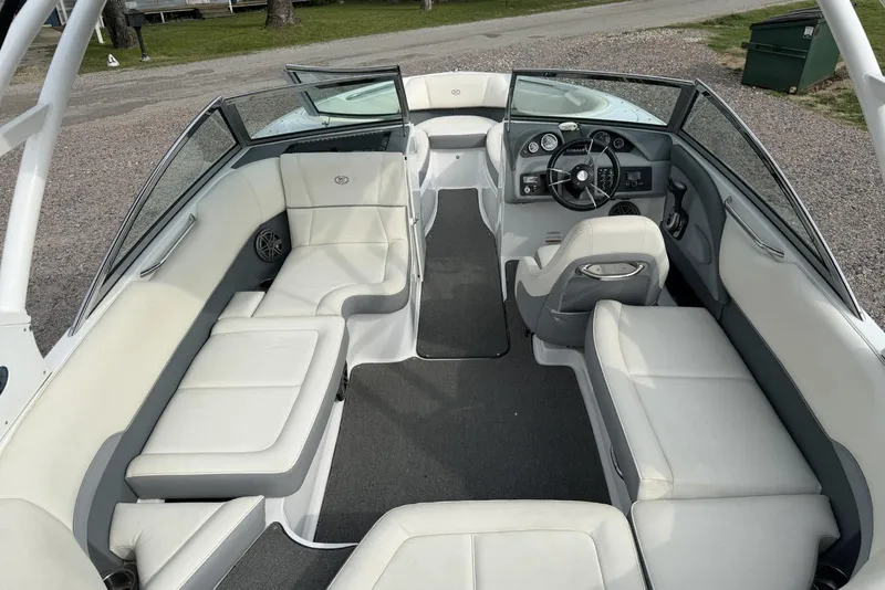 Slide: The Image of 2016 Cobalt 220 boat interior with white seating and modern dashboard design. - 17